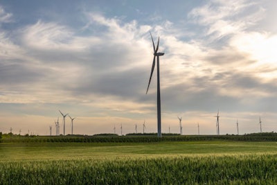 Wind Turbine In Wheat Field In Sunset. Sustainable Energy. Susta