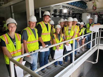 Alex Kerrigan (far right), vice president of project development for Todd & Sargent, guest lectures a group of ISU students at the ISU KENT Feed Mill and Grain Science Complex.